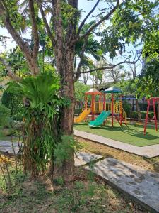 a park with a playground with a slide at Minie House Hatyai in Hat Yai