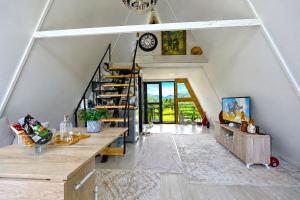 a room with a staircase and a clock on the wall at Villa Olivia in Elbasan