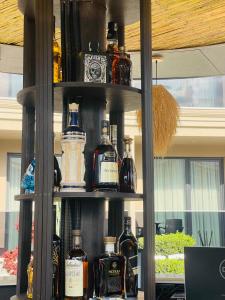 a shelf filled with lots of bottles of alcohol at EBBI HOTEL in Dhërmi