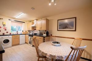 a kitchen with a table with a bowl on it at Green Beck Cottage, within walking distance of the lake, shops, pubs & restaurants of Coniston in Coniston