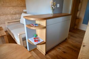 a small table in a room with a couch at Mein Refugium Relax Tiny Haus in Unteriberg +12 photos