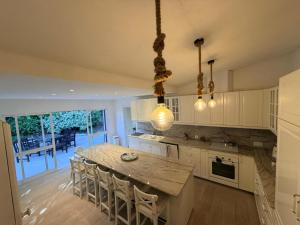 a kitchen with a large wooden table and chairs at Royal Course Villa, Vale do Lobo in Vale do Lobo