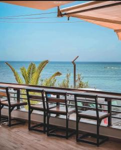 a view of the ocean from a deck with benches at Cozy house in Nabeul