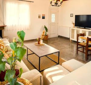 a living room with a couch and a table at Acheron House in Gliki