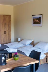 a room with two beds and a wooden table at Bardo CAMP in Bardo