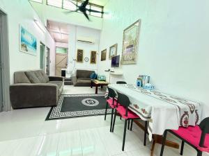 a living room with a table and a couch at Lanang Islamic Homestay in Bedung