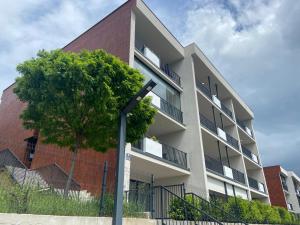 an apartment building with a tree in front of it at Unin Apartman, Kosmaj Renew, Rogača in Rogača