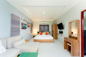 a living room with a bed and a couch at Malinee Resort in Bang Tao Beach +55 photos