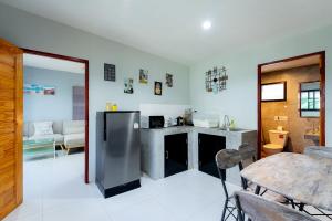 a kitchen with a stainless steel refrigerator and a table at Malinee Resort in Bang Tao Beach