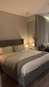 a bedroom with a large bed and a couch at استديو in Al Khobar