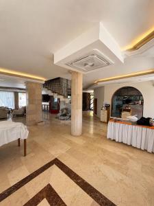 a large living room with a table in a room at Calis Hotel in Çeşme