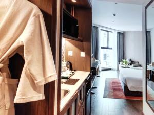 a bathroom with a sink and a bedroom with a bed at Pristine Coast Residences in Phan Thiet