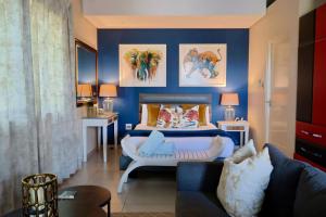 a blue bedroom with a bed and a couch at Breakers View in Sheffield Beach