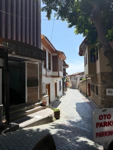 an empty street with a parking sign next to a building at Sunrise Hotel in Antalya