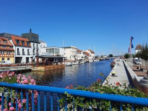 a view of a river with boats in a city at Fh "luv" in Ueckermünde