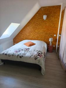 a bedroom with a bed in a attic at La maison du 116 in Gravelines