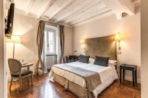 a hotel room with a large bed and a desk at Hotel Clitunno in Spoleto +106 photos