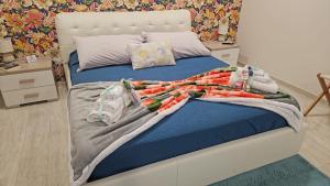 a bedroom with a large bed with blue sheets at Shine Flowers Room in Scordia +33 photos