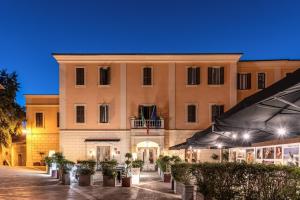 a large building with plants in front of it at Hotel Clitunno in Spoleto