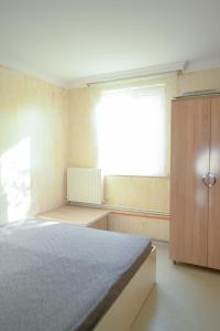 a bedroom with a bed and a dresser and a window at apartament dato in Batumi