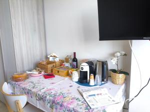 a table with a flowered table cloth on it at Shine Flowers Room in Scordia