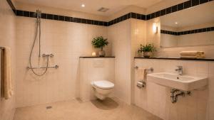 a bathroom with a toilet and a sink at Hotel Am Weberplatz in Dresden +14 photos