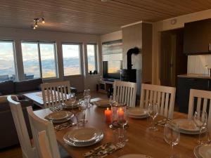 a dining room with a table and chairs with a view at Sauna & Mountain Views - Ski-in Ski-out Luxury in Vossevangen