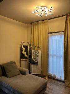 a living room with a couch and a chandelier at Dar Sahha in Nara