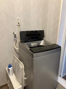 a washing machine in a room with a phone at Dar Sahha in Nara +47 photos
