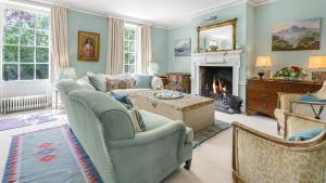 a living room with a couch and a fireplace at West Kennett House in Marlborough +28 photos