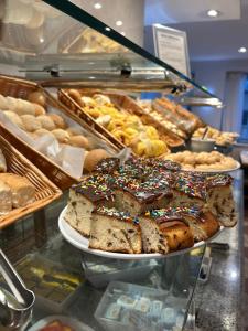 a display case in a bakery with different types of pastries at Real Palace Hotel in Rio de Janeiro