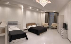 a hotel room with two beds and a television at Wave Inn boutique in Yerevan
