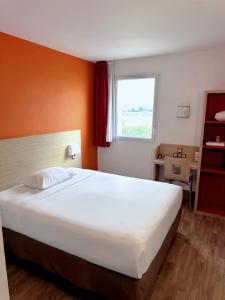 a bedroom with a large white bed and a window at HubOne3 Istres in Istres