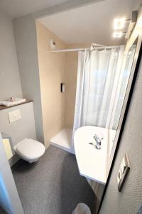 a bathroom with a sink and a toilet at HubOne3 Istres in Istres