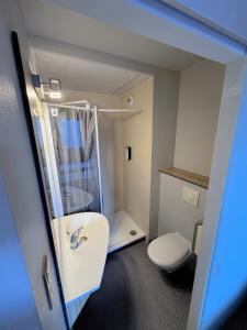 a small bathroom with a toilet and a sink at HubOne3 Istres in Istres