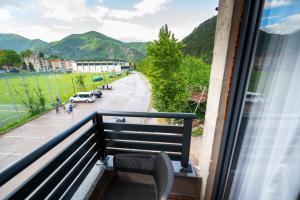 a balcony with a chair and a view of a street at Apartmani Narona in Jablanica