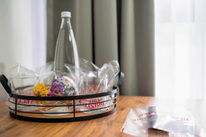a drink bottle and some food in a basket on a table at Apartmani Narona in Jablanica