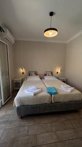 a bedroom with a large bed with towels on it at Le Torri Villas by Nidri holiday villas in Nydri