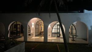 a house with arches and a room with a table at Casa Dega in Balapitiya +5 photos