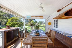 a patio with a wooden table and chairs at Parkview Cottage Portsea in Portsea
