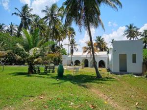 a house in a park with palm trees at Casa Dega in Balapitiya