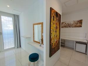 a white room with a mirror and a desk at Villa Luxury Paradise Suites in Salobreña