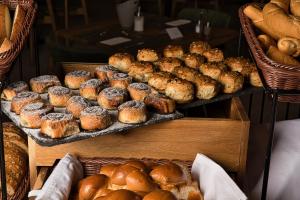 a display of different types of breads and pastries at AquaMed Hotel Harkány in Harkány