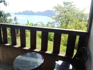 a balcony with a table and a view of the ocean at MountainSide Lodge in El Nido