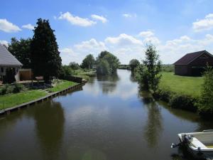 a river with a boat in the middle at Ferienwohnung Biesterfeld in Bedekaspel