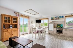 a kitchen with a table and a dining room at Ferienwohnung Saustrup in Saustrup