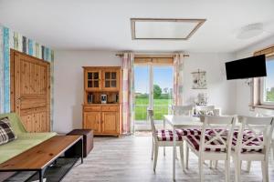 a living room with a table and chairs and a television at Ferienwohnung Saustrup in Saustrup