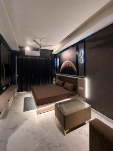 a living room with a bed and a couch at Moon Escape Studio in Ghaziabad +8 photos