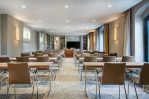 a room with tables and chairs and a podium at Grand Hotel Las Dunas, Autograph Collection in Estepona +114 photos