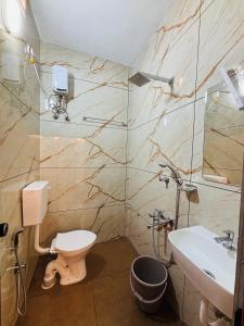 a bathroom with a toilet and a sink at Fort Grande INN in Fort Kochi +28 photos
